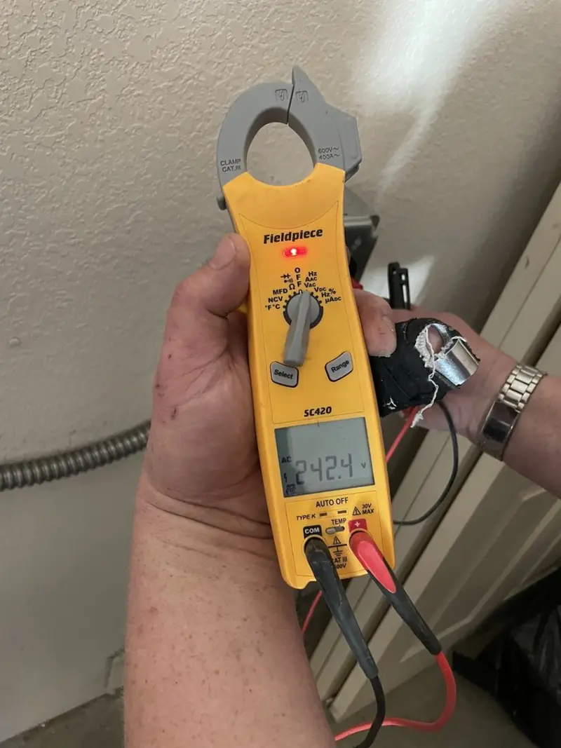 Voltage testing with clamp meter during Outlet Installation in Laurel Bay